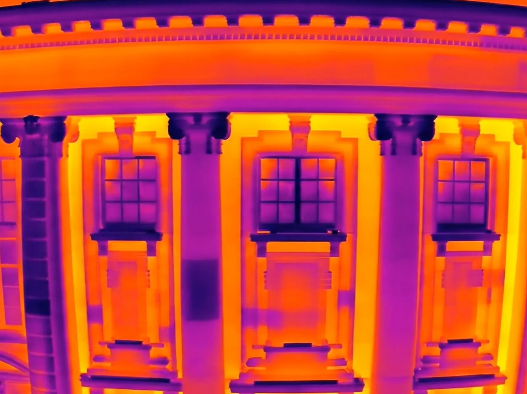Thermal image showing heat loss patterns on building facade