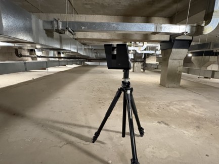 Matterport Pro 3 camera on tripod capturing the basement plant void of the Glasgow Royal Concert Hall, with exposed concrete structure and ductwork overhead